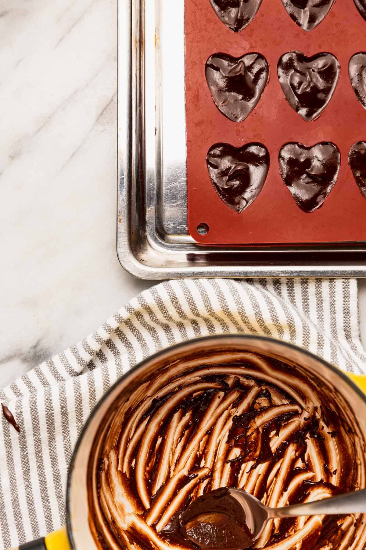 Heart-shaped candy molds filled with chocolate rosemary truffles.