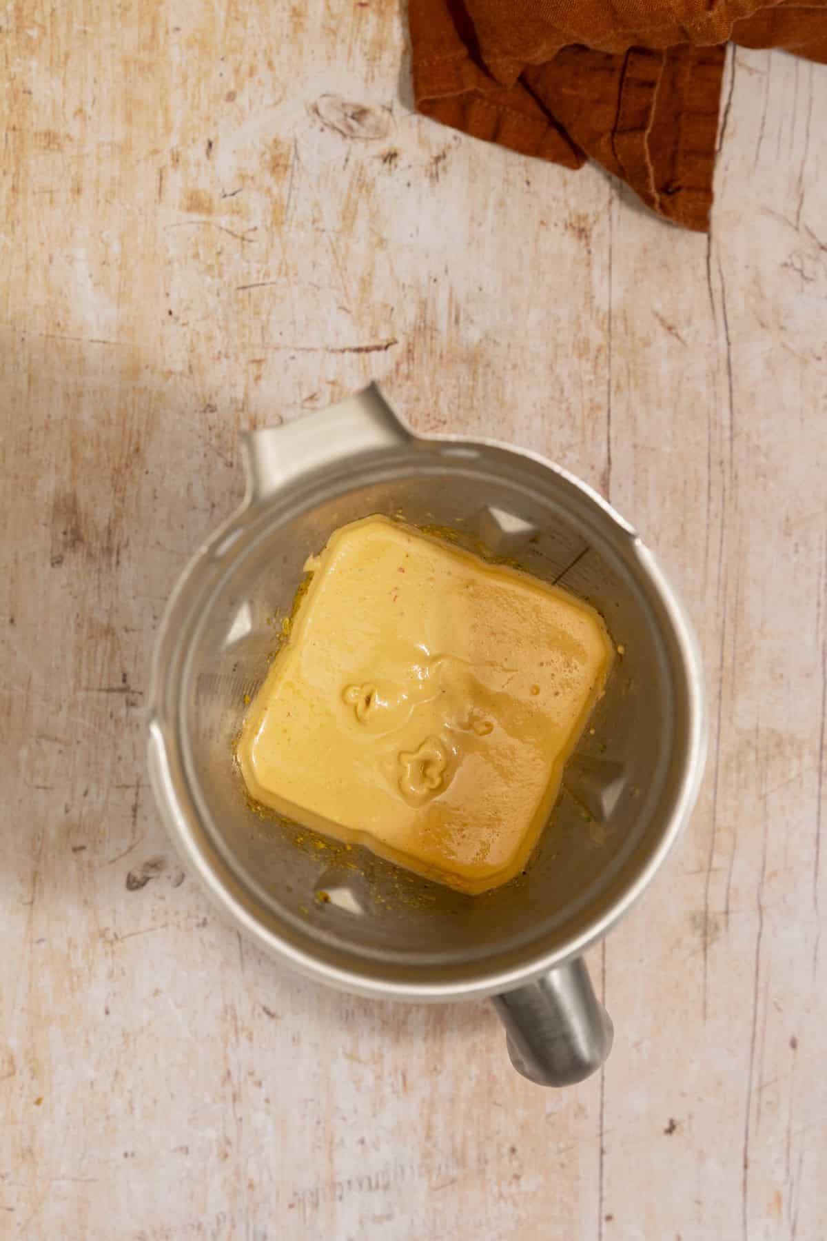 A stainless steel blender filled with creamy chipotle lime sauce.