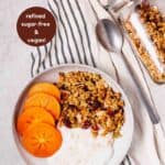 A bowl of homemade orange pecan granola, yogurt, and fruit with text indicating the granola is vegan, oil-free, and refined sugar-free.