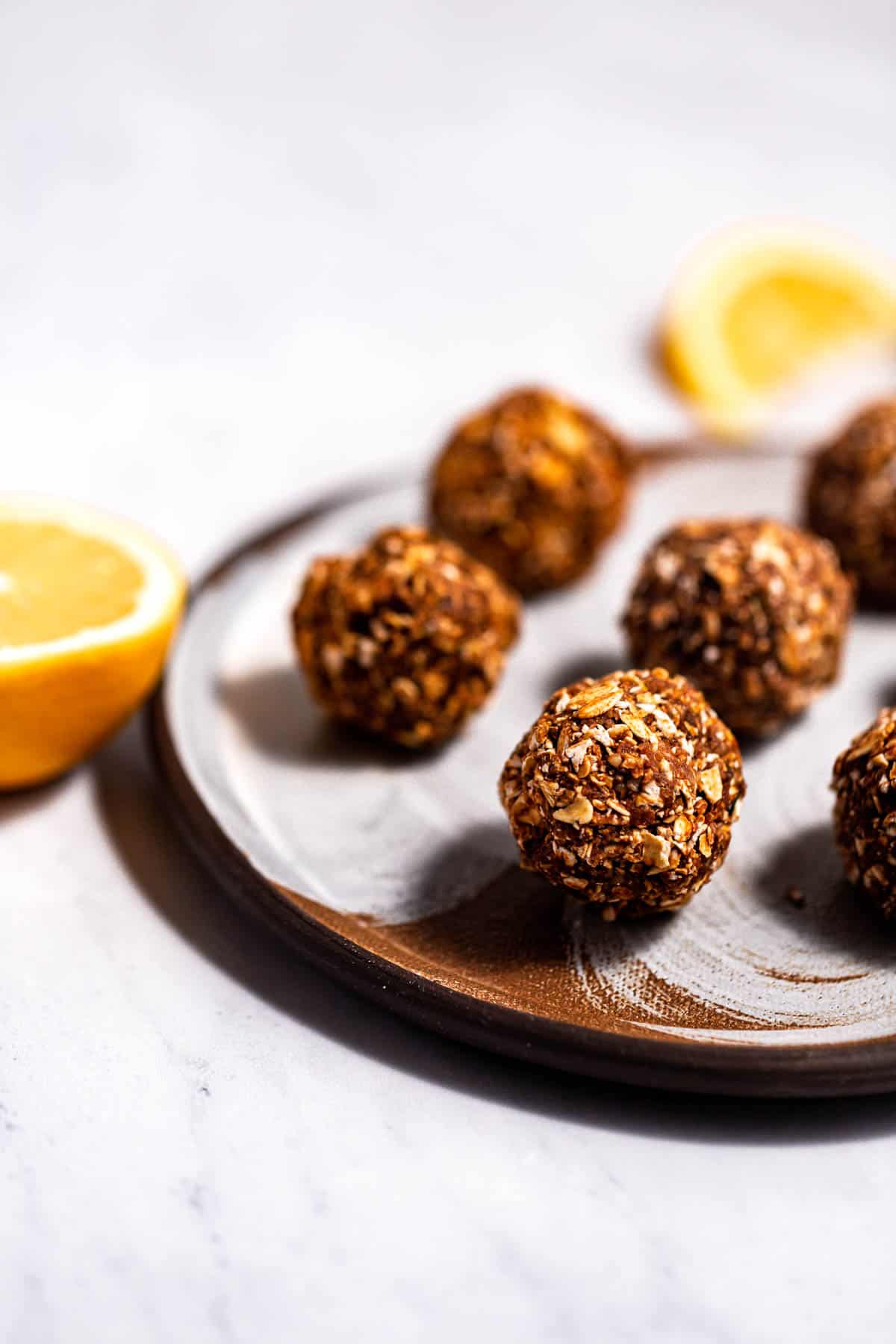 Chocolate orange energy bites on a serving plate.