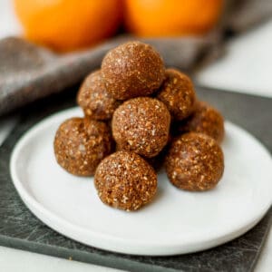 a pyramid of chocolate energy balls on a white plate