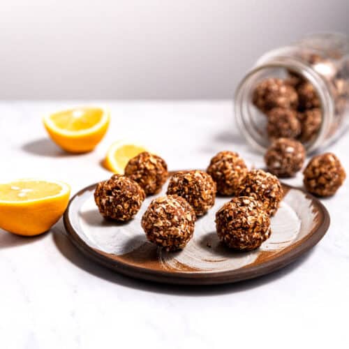 Chocolate orange energy bites (or balls) on a serving plate and in a jar.
