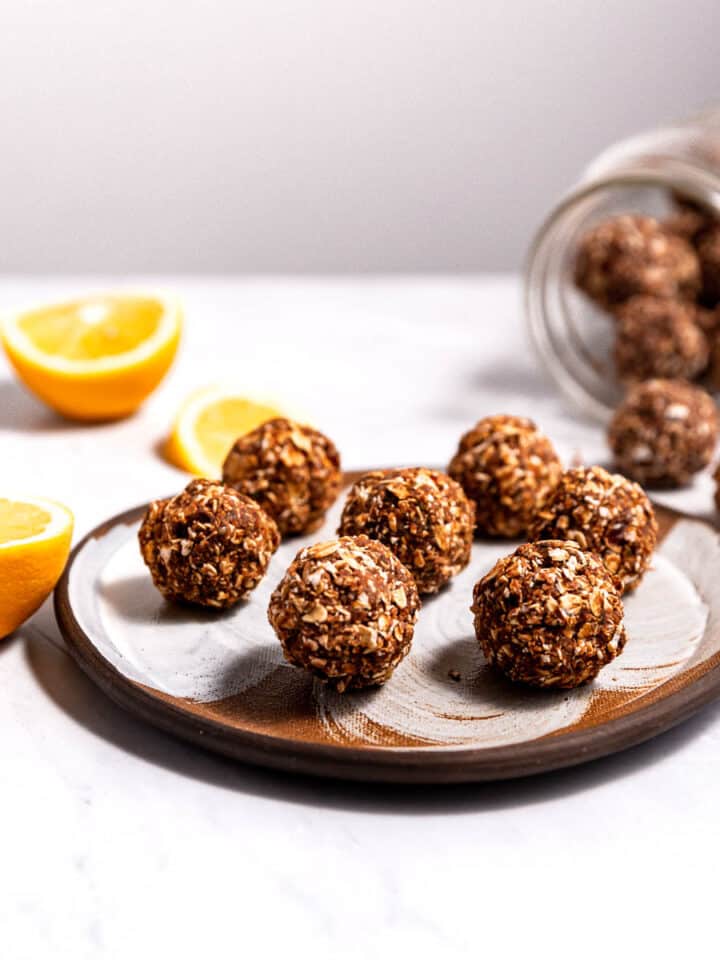 Chocolate orange energy bites (or balls) on a serving plate and in a jar.