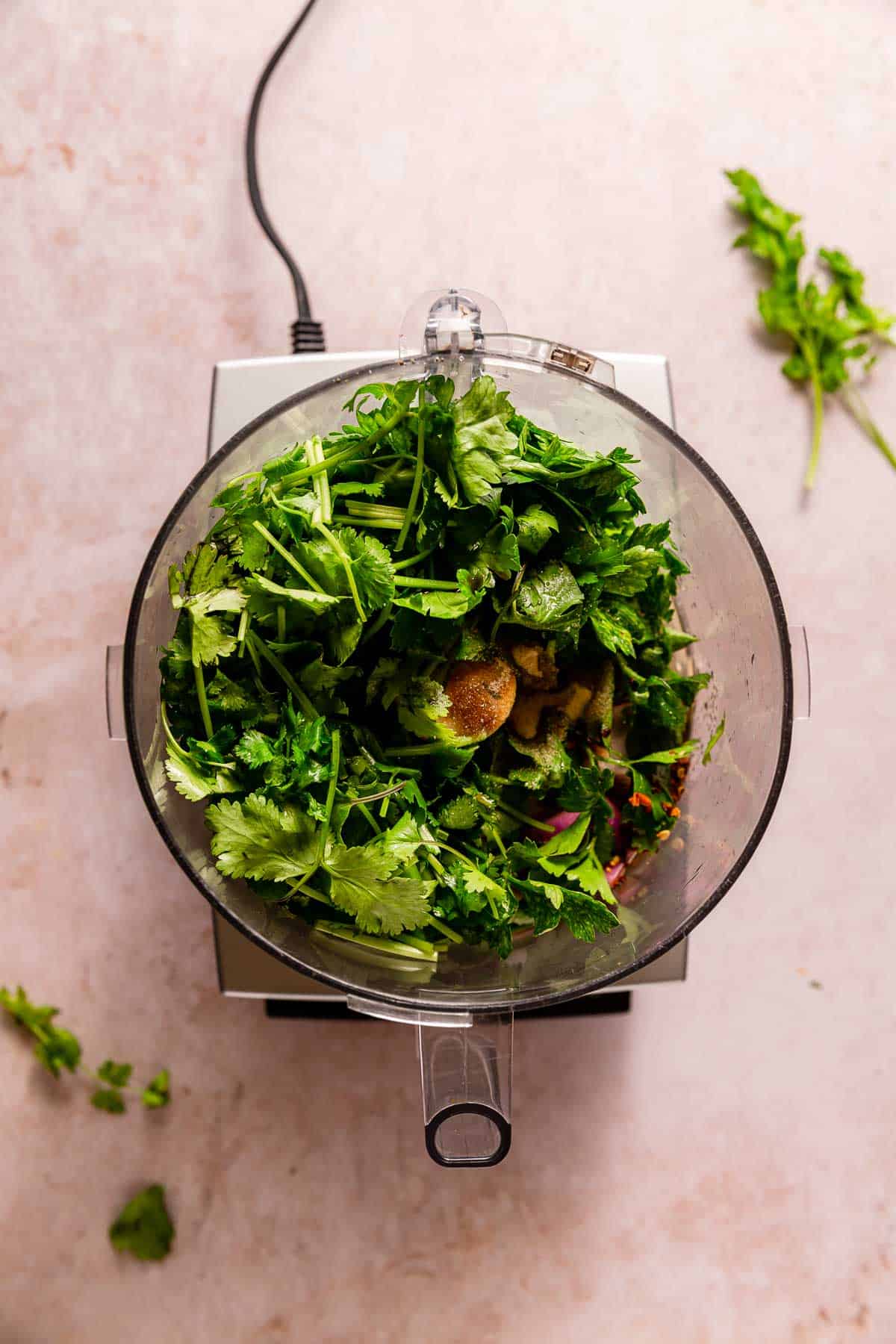 Chimichurri ingredients in a food processor.