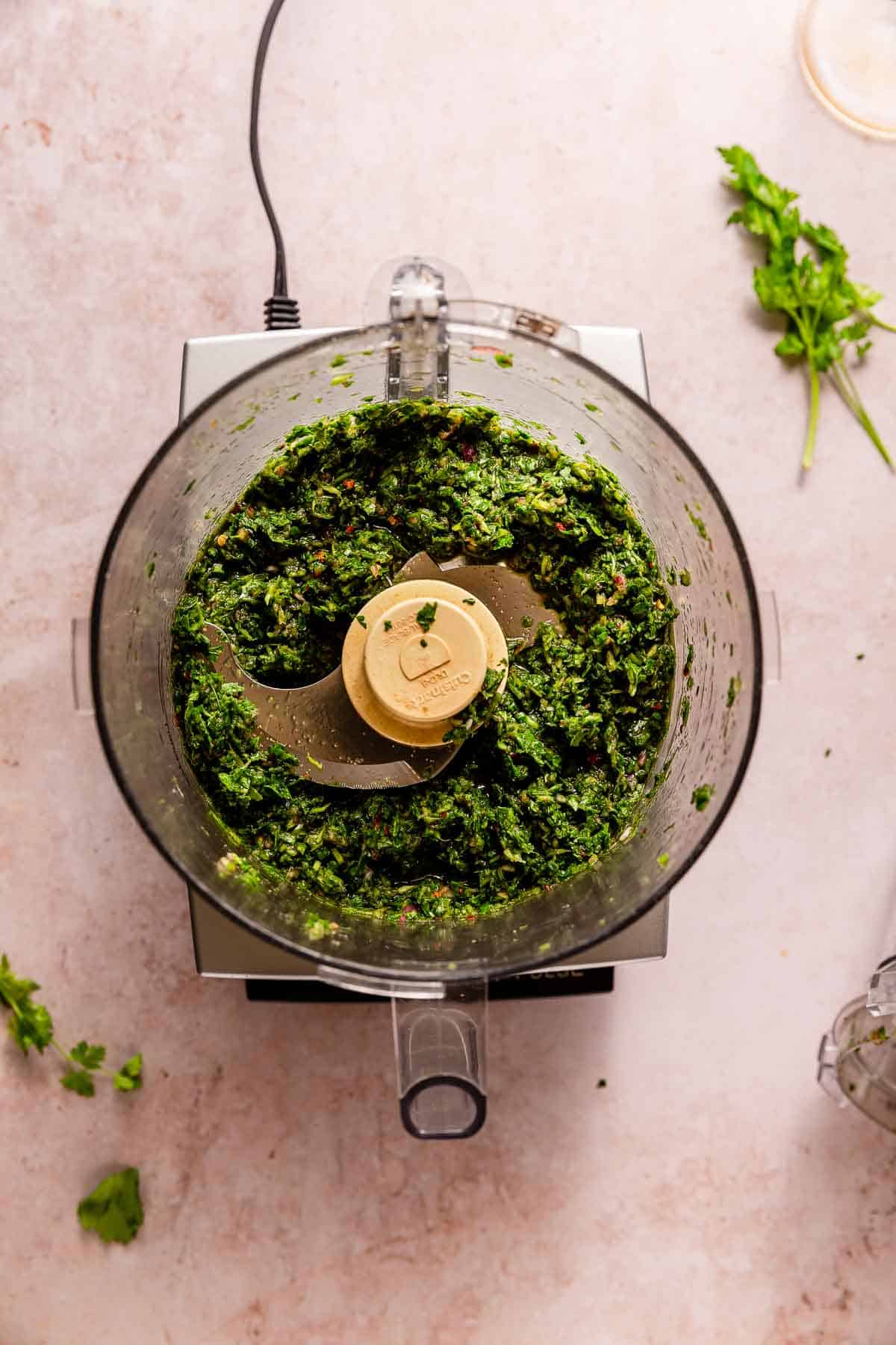 Processed chimichurri in a food processor.