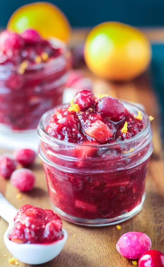 A jar filled with cranberry orange pear sauce.