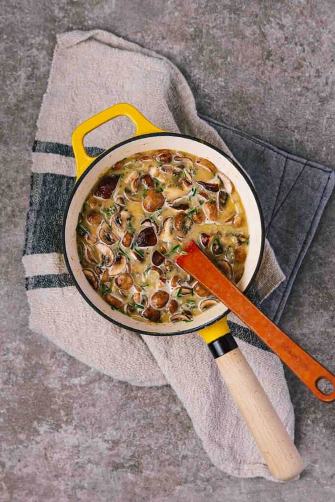 a pot filled with mushroom gravy ingredients