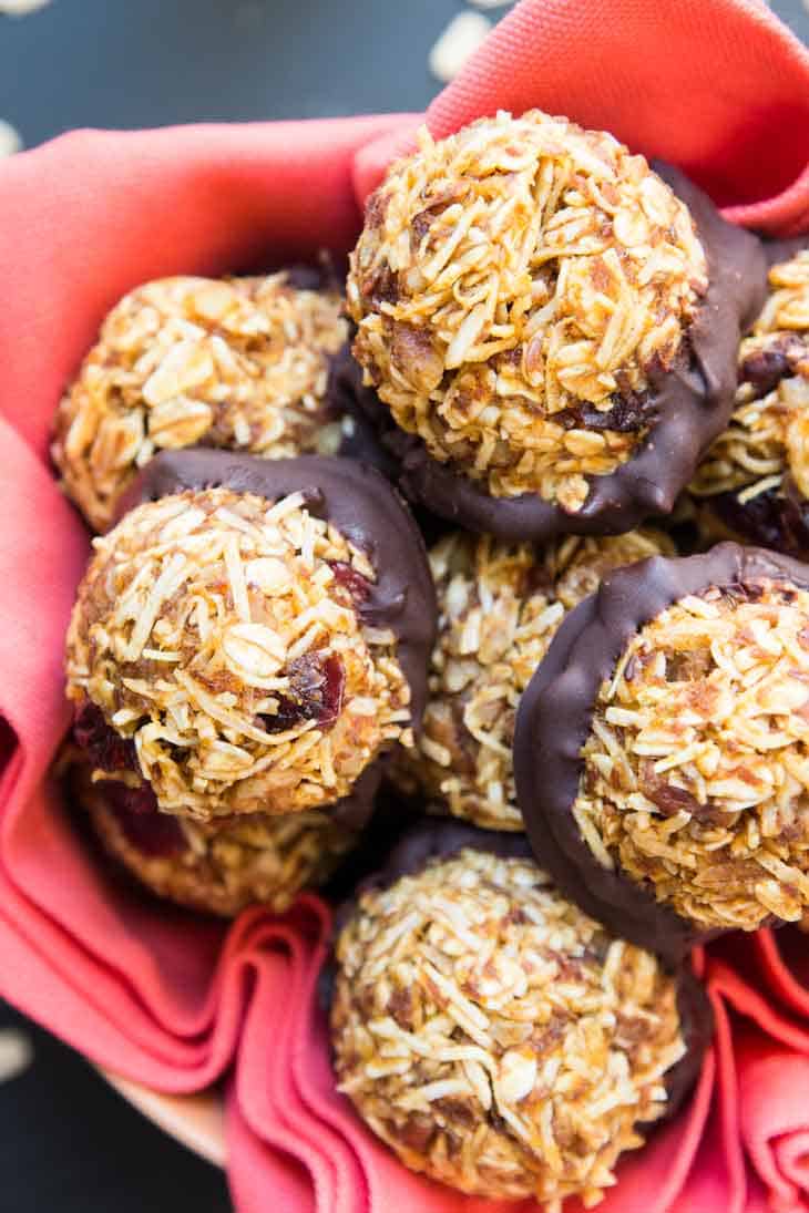 A basket filled with no-bake vegan pumpkin cookies with coconut and pecans.