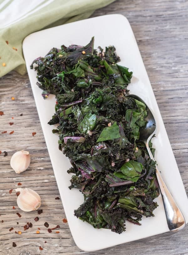 A rectangle serving platter filled with garlicky sauteed greens.