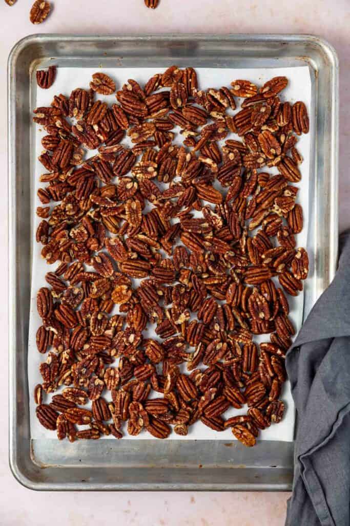 a baking tray of toasted maple pecans