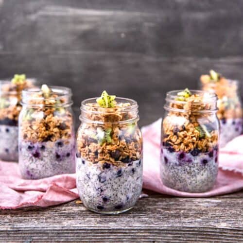 A collection of jars filled with chia pudding parfait and peanut butter chocolate chip granola.