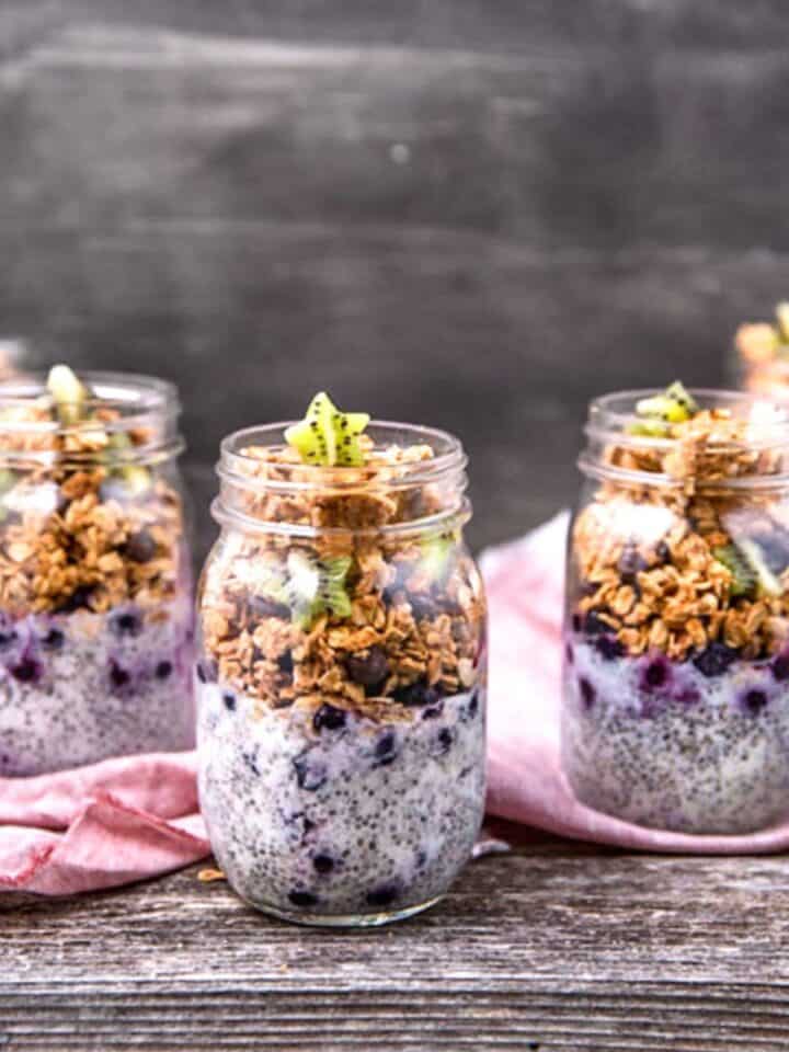 A collection of jars filled with chia pudding parfait and peanut butter chocolate chip granola.