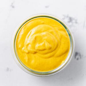 a jar of creamy vegan cheese sauce