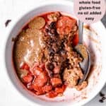A bowl of nut butter, strawberry sauce, chocolate, and oatmeal.