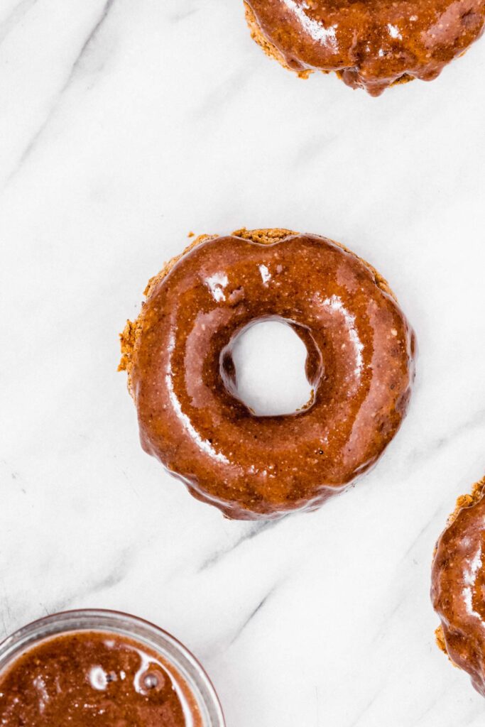 A donut frosted with maple pecan sauce.