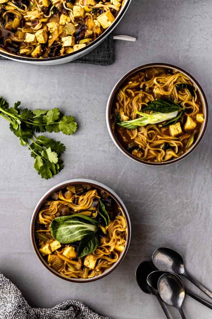 golden ramen bowls with cilantro garnish