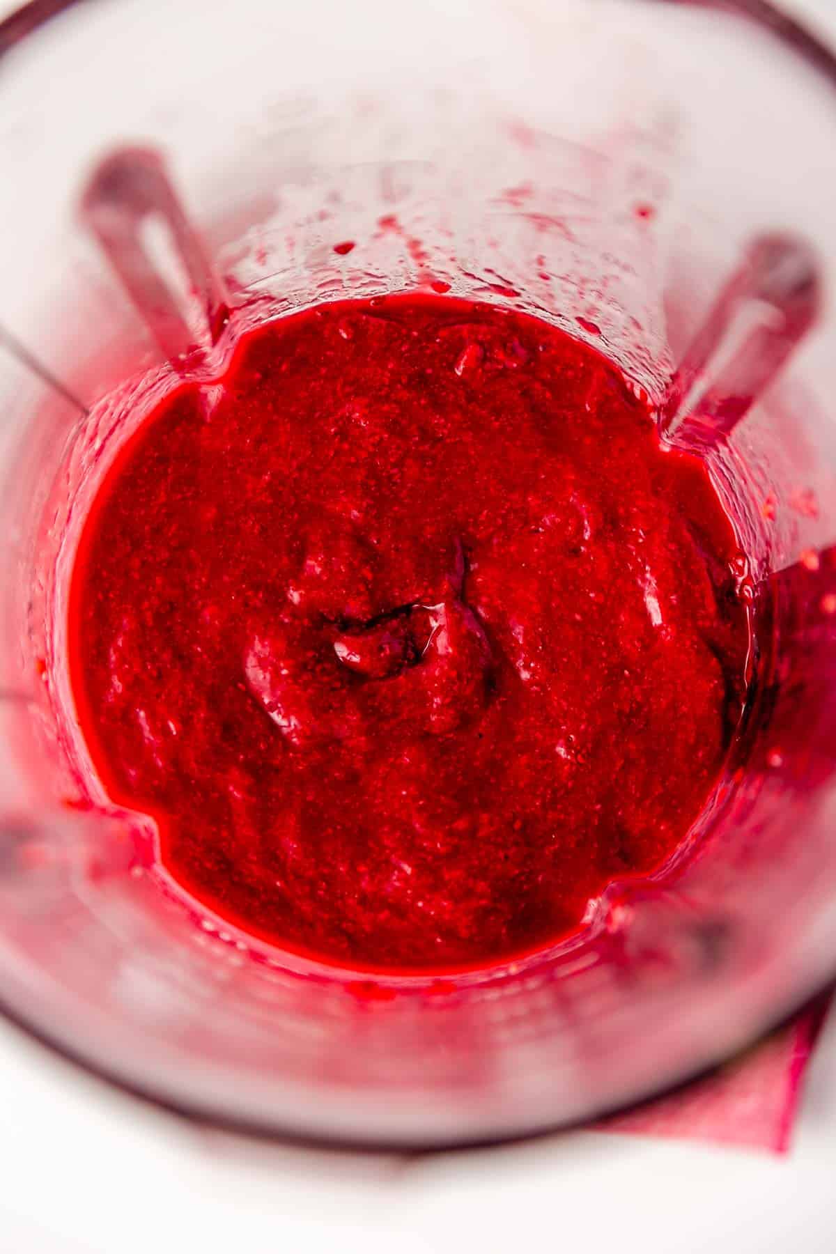 A blender filled with smooth raspberry chia jam.