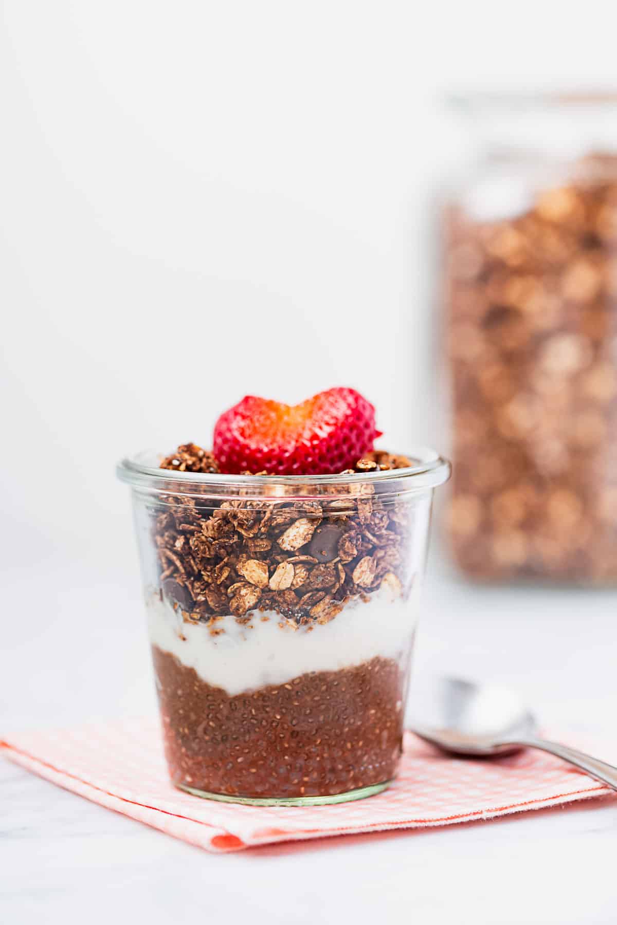 A chocolate chia parfait topped with homemade chocolate berry granola.