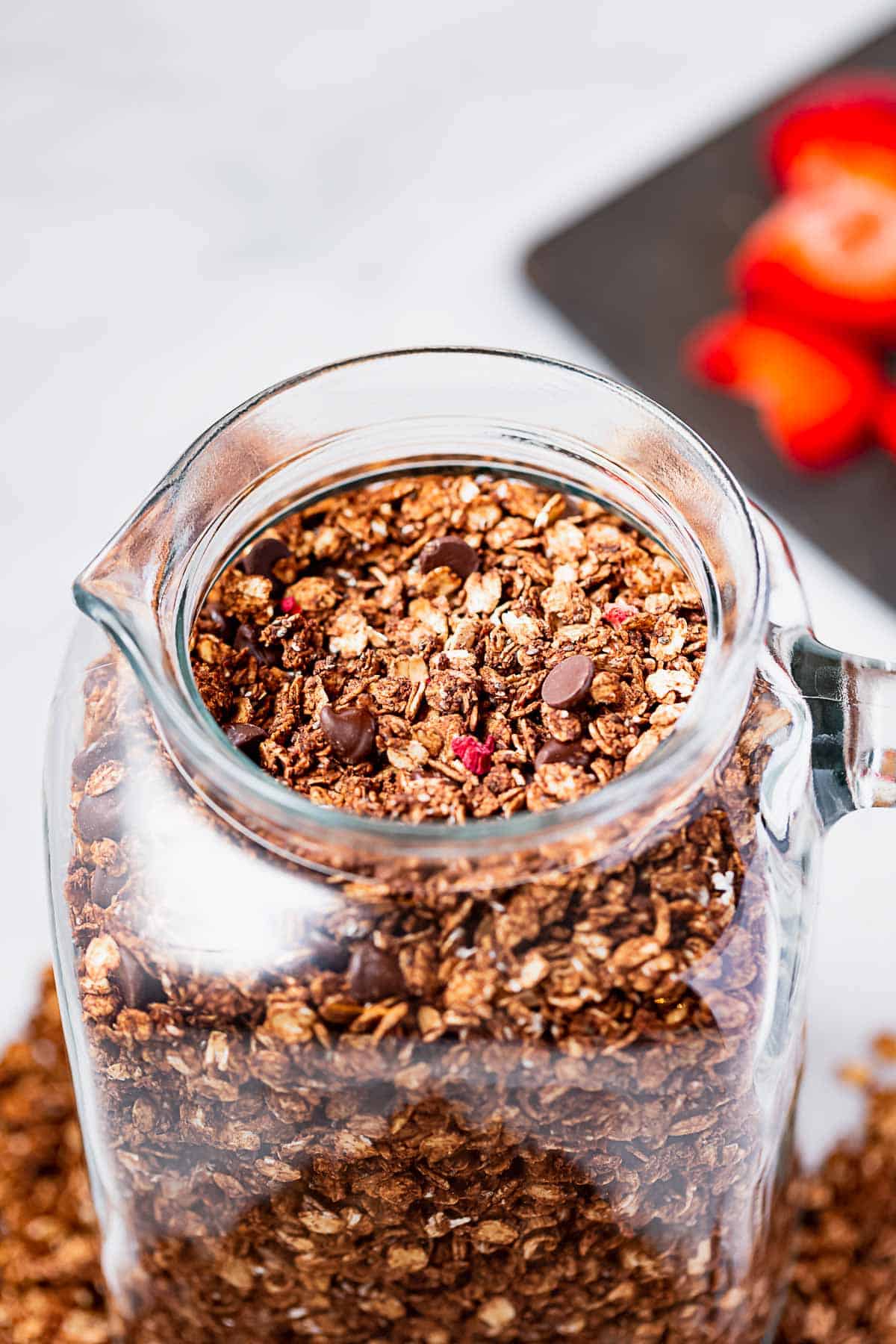 A large jar of homemade strawberry chocolate granola.