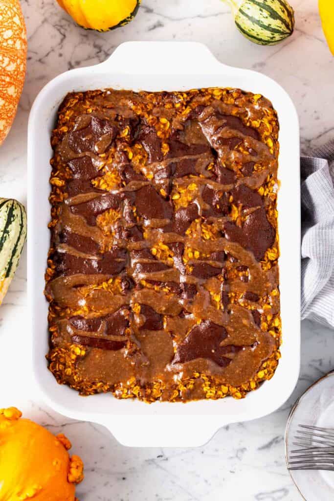 A 9x13 pan filled with pumpkin chocolate pecan swirl baked oatmeal