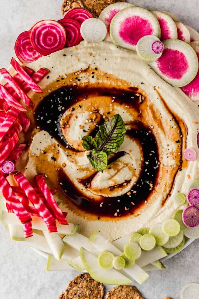 Smooth, creamy oil-free hummus topped with balsamic glaze and colorful veggies.