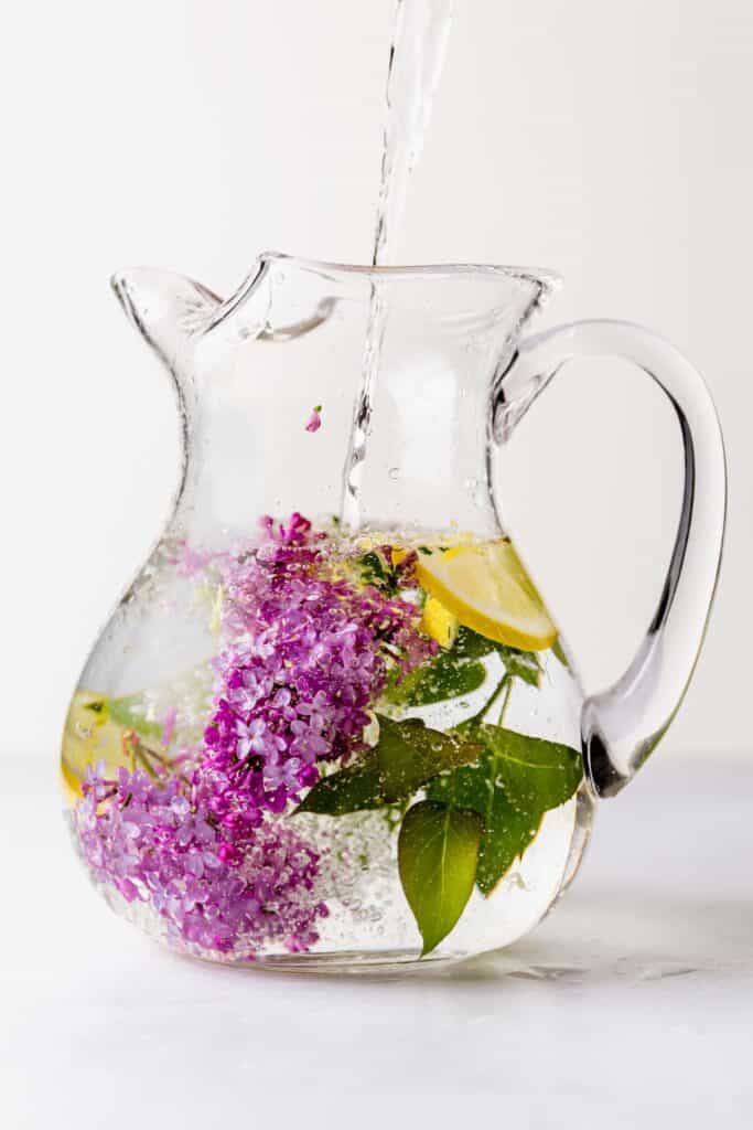 Lilac and lemon water in a large pitcher