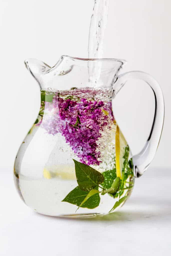 Lilac and lemon water in a large pitcher