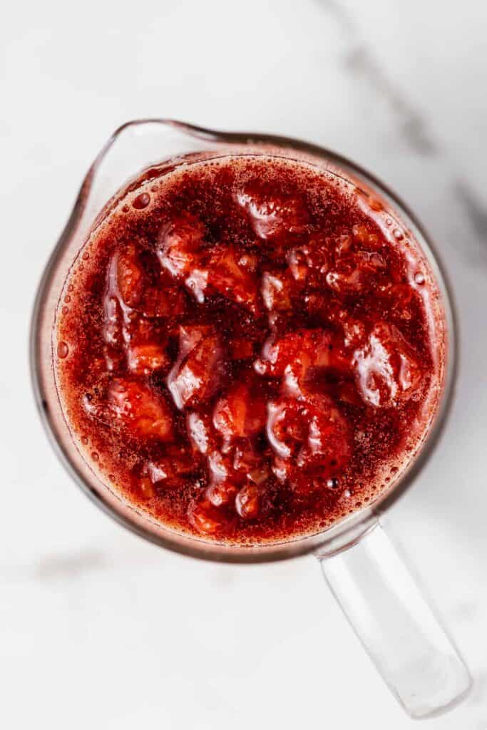 looking down on a pitcher full of strawberry rhubarb compote