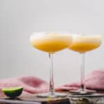 Two Piña Coladas with foamy tops.