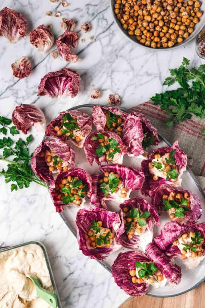 parsley, crispy chickpeas, and hummus in radicchio leaves