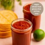 pinterest graphic for enchilada sauce recipe showing side view of two sauce jars