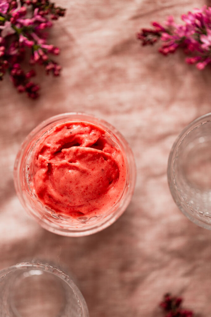 Freshly made nondairy strawberry frozen yogurt in a glass.