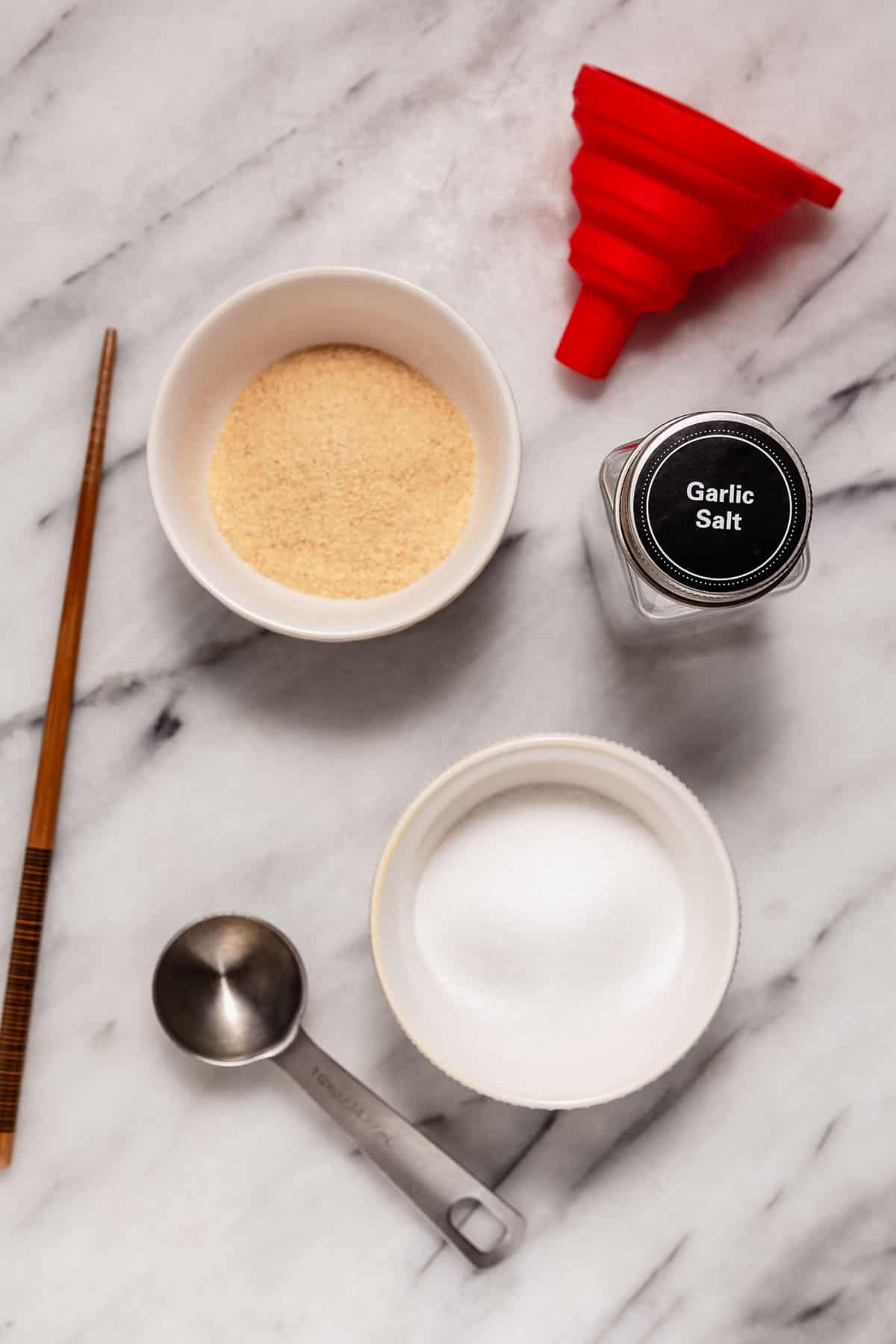 Ingredients and tools for making garlic salt.