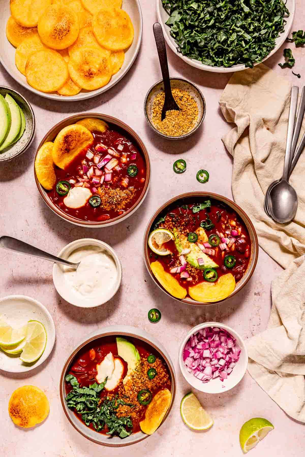 Chili bowls with toasted polenta rounds, greens, vegan sour cream. and smoky hemp heart seasoning.