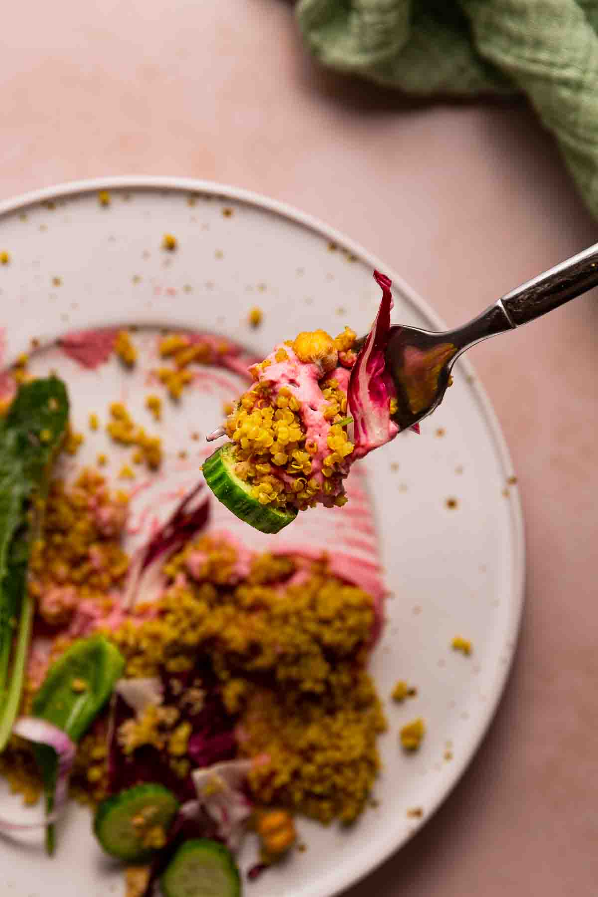 A forkful of cucumber, quinoa, radicchio, and beet hummus.