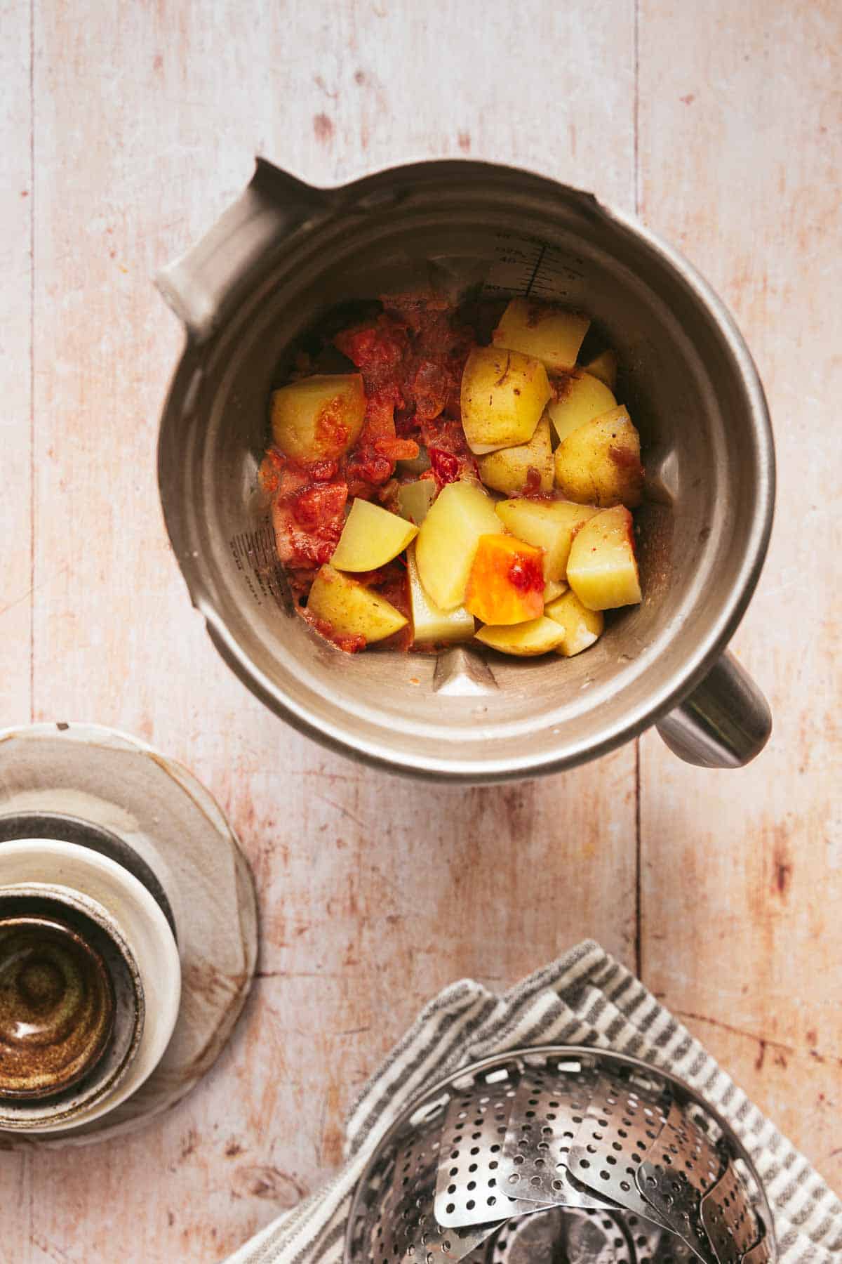 Plant-based queso ingredients in a stainless steel blender.