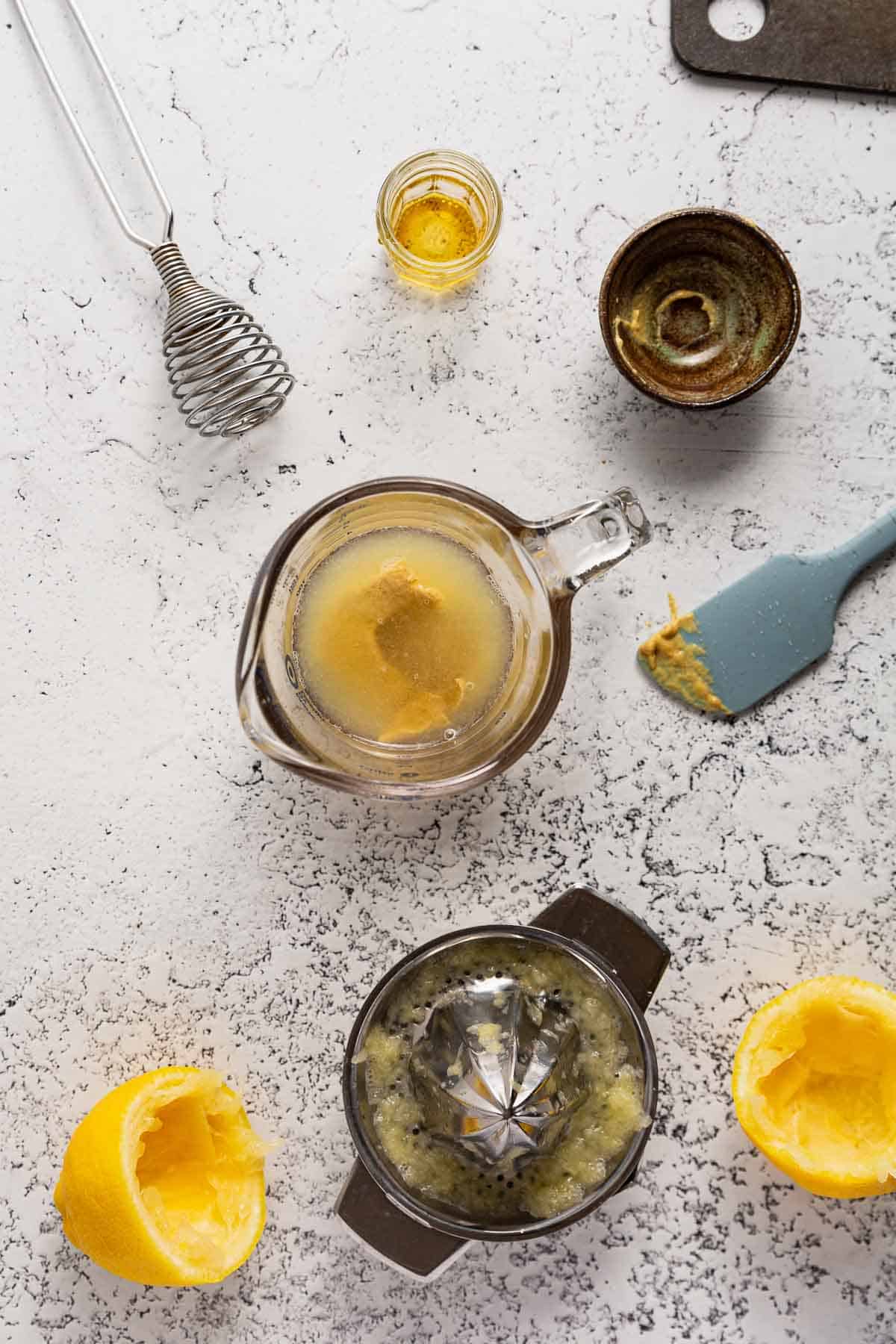 Mustard added to lemon juice for maple dijon salad dressing.