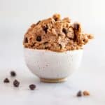 A small white bowl filled with vegan gluten-free chocolate chip cookie dough, with text saying it's quick & easy, oil-free, fiber & protein-rich.