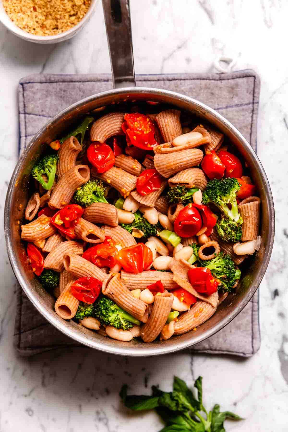 Roasted broccoli and cherry tomatoes, white beans, and basil stirred into a pot of pasta.