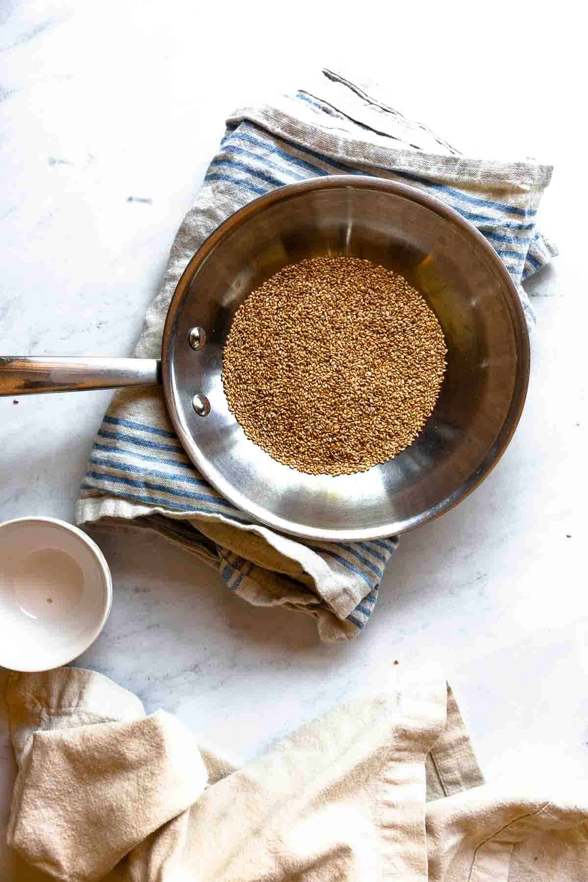 Sesame seeds toasted in a pan as an alternative to roasting them for this sesame dressing.