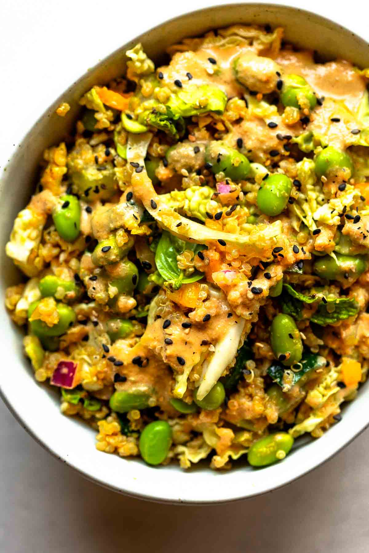 A quinoa edamame salad topped with roasted sesame dressing.