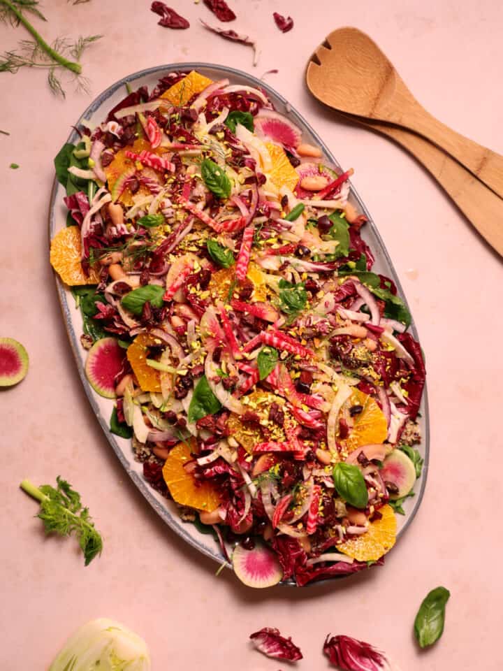 A beautiful, colorful vegan winter salad featuring radicchio, oranges, fennel, quinoa, and cannellini beans.